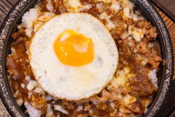 Japanese and Thai fusion food with fried egg on top.