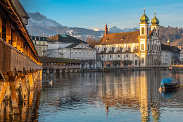 The Chapel bridge and the Jesuit Church of Lucern with Mount Pilatus in the background, Central...