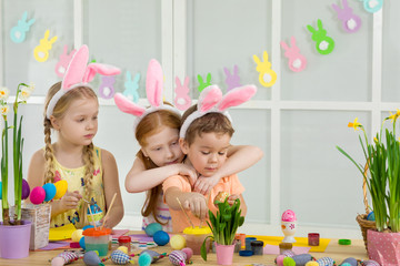 cute kids painting Easter eggs at home. adorable children prepare for easter