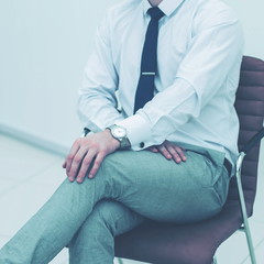 Obraz premium concept of business success - businessman sitting on a chair in 