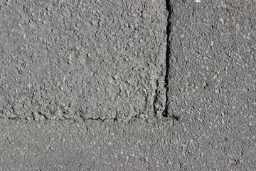 Asphalt surface texture detail with cut line crack fracture close up