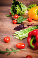 Various raw vegetables on brown wooden background