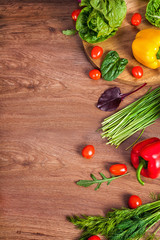 Various raw vegetables on brown wooden background