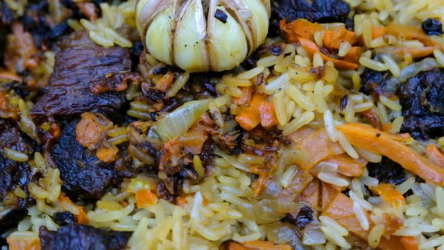 pilaf Uzbek beautifully laid rotates in front of the camera close-up