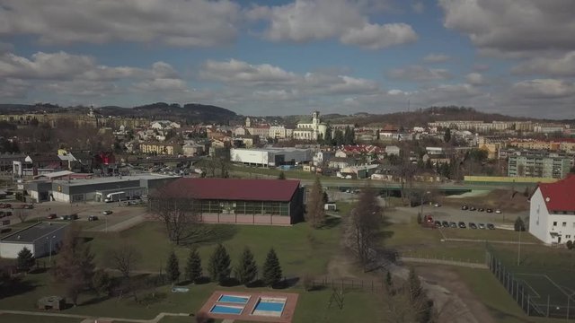 Gorlice, Poland - 3 9 2019: Panorama of the historic center of the European medieval city on the picturesque green hills. Trips to architectural monuments, temples, quarters and sports complex MOSiR