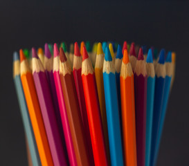 Close up shot of color pencil pile pencil nibs on dark background