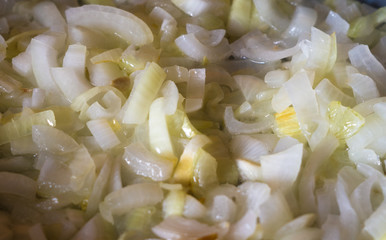 Frying finely chopped and onions in boiling oil, close-up