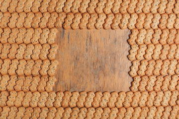 Composition of crackers with poppy seeds laid out on a wooden background