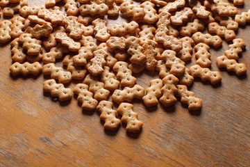 Composition of crackers with poppy seeds, spread out on a wooden background