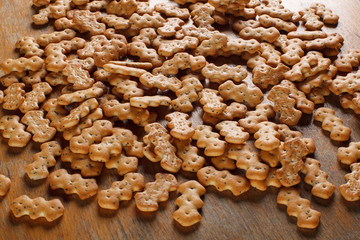 Composition of crackers with poppy seeds, spread out on a wooden background