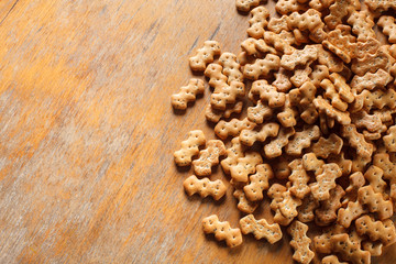 Composition of crackers with poppy seeds laid out on a wooden background