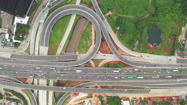 Top down view of Depok Antasari freeway interchange from a drone flying down. Shot in 4k resolution