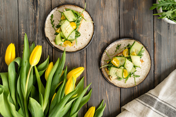 Delicious sandwich with cucumber, arugula, tomato and mustard. Top view, rustic, flat lay.