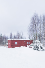 Wooden shed in the forest on the territory of a private house in winter