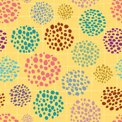 Colourful hand drawn circular paint dots in scattered design. Seamless vector pattern on yellow background. Abstract summer vibe. Great for stationery, giftwrap, wellbeing, natural, organic products