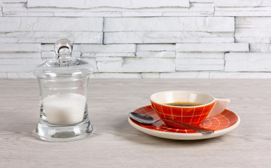 Modern Cup of Coffee and a Sugar Bowl on a Wooden Table