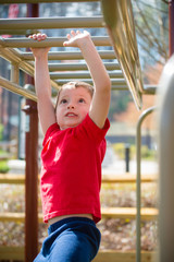 Cute and happy boy playing on playground