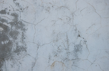 Gray concrete texture background. Cracks. Scratches. Damage. Cracked stone wall background.