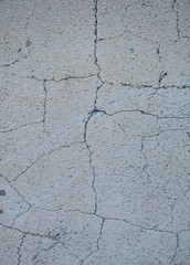 Gray concrete texture background. Cracks. Scratches. Damage. Cracked stone wall background.