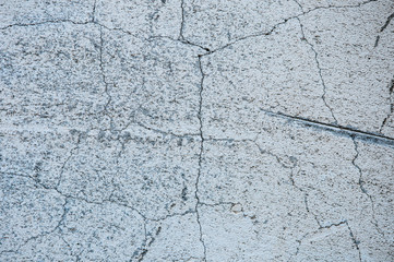 Gray concrete texture background. Cracks. Scratches. Damage. Cracked stone wall background.