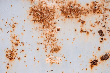 Background texture of old rusty damaged metal. Remains of multi-colored paint on an iron sheet.