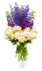 Bouquet of beautiful flowers roses and delphinium elatum in vase isolated on white background. Floral pattern composition. Flat lay, top view. Still life