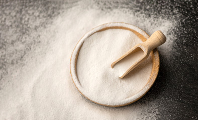 Plate with baking soda on wooden background