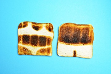 Two toasts are on a colorful background - both are not toasted all over the surface but show the...