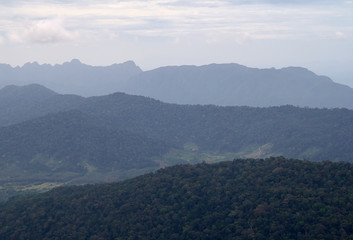 Amazing landscape view from the observation tower at Gunung Raya, the highest point in Langkawi, Malaysia. Distant mountains in the mist and the ocean on the background. Tranquility and serenity.