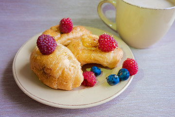 delicious summer juicy blueberry and raspberry berry with honey droplets on a fresh croissant