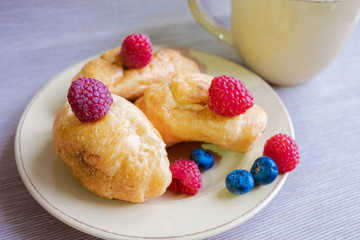 delicious summer juicy blueberry and raspberry berry with honey droplets on a fresh croissant