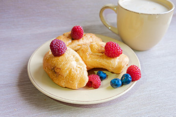 delicious summer juicy blueberry and raspberry berry with honey droplets on a fresh croissant