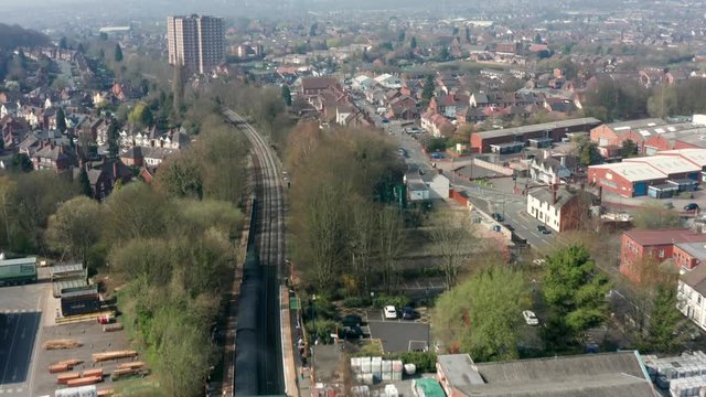 Steam train flying through busy town