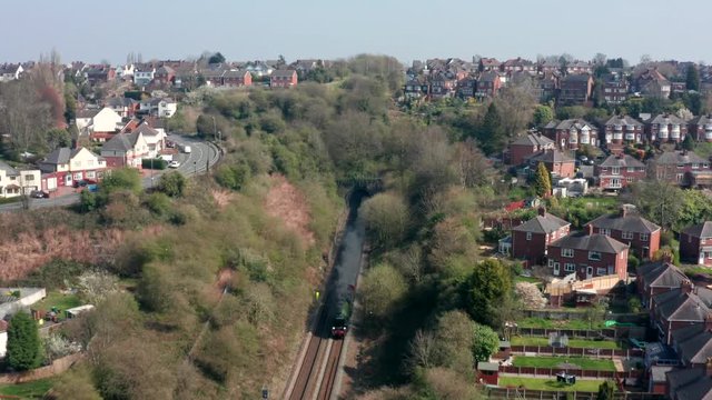 Steam train leaving tunnel
