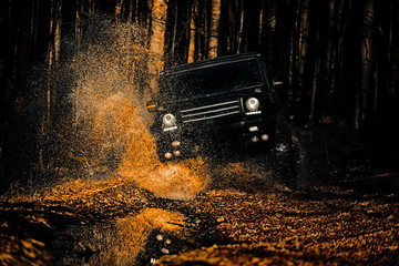 Off-road vehicle goes on the mountain. Mud and water splash in off-road racing. Drag racing car burns rubber. Extreme. Off-road car. Best Off Road Vehicles. Rally racing. © Volodymyr