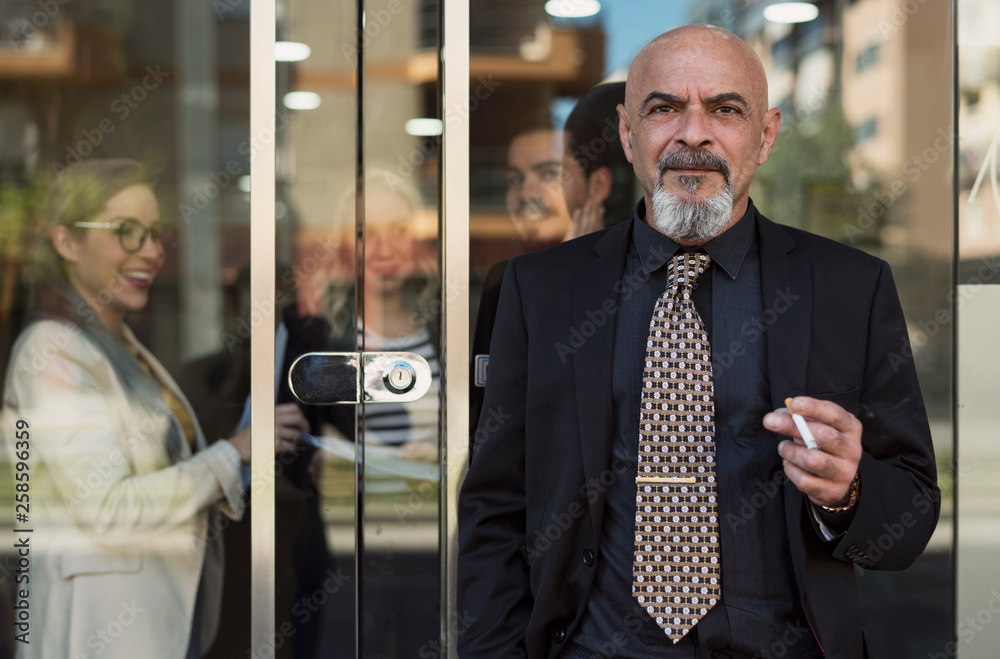 Poster mature senior man smoking in office door