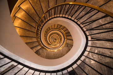 Elliptical spiral stairs round gold brown white