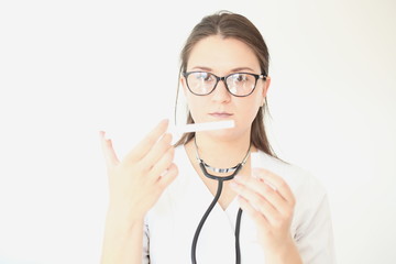 Portrait of beautiful female doctor. Medicine representative concept on brick background