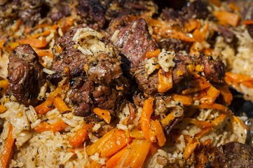 Rice pilaf, also known as plov or pilau, a national cuisine dish in Uzbekistan and other Central and South Asian countries, as well as in the Caucasus and other regions. 