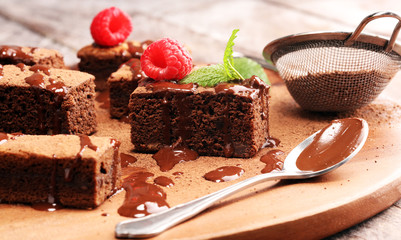 chocolate brownie cake dessert with raspberry and spices on a rustic background