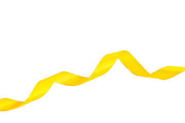 Yellow ribbon isolated on white background. Spiral of satin ribbons. Festive decor on a white background.