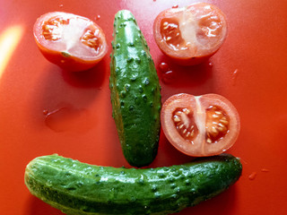 The tomatoes and ripe cucumbers. Fresh tomatoes and cucumbers. Natural vegetables.