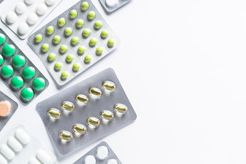 Pills in a blister on white top view.