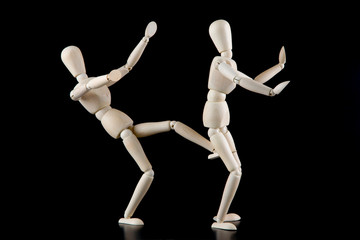 Mannequin dolls in interaction isolated on black background