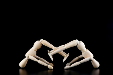 Mannequin dolls in interaction isolated on black background