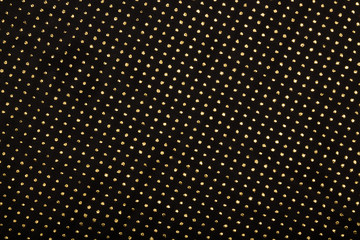 Black textile with golden metallic dots decor