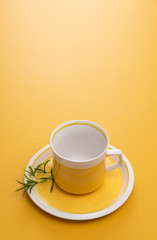 Ceramic teacup on yellow background