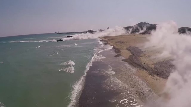 Assault amphibious vehicles arriving to the beach