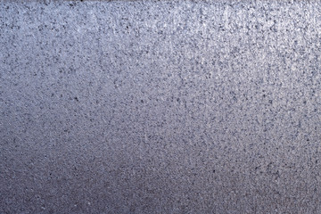 Detailed metallic texture of compressed melted and hammered and dented metal with gradient of shades