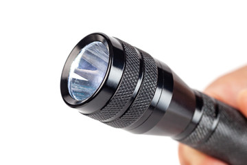 Hand holding flashlight on white background